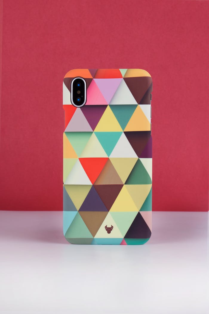 services-01 Vibrant phone case with geometric pattern displayed on a red backdrop, perfect for modern design lovers.